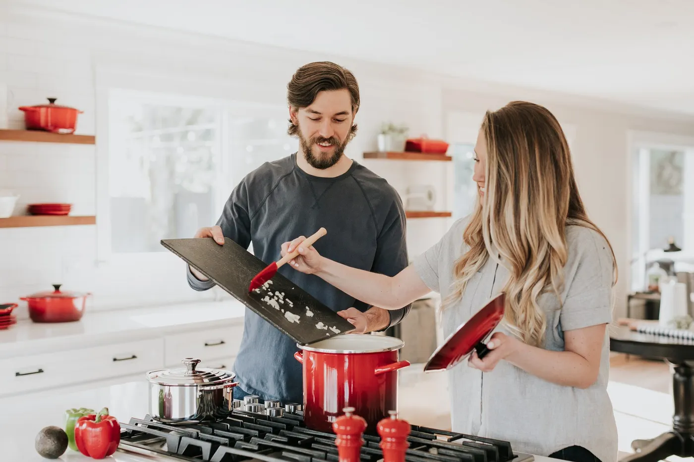 A couple cooking together in their kitchen